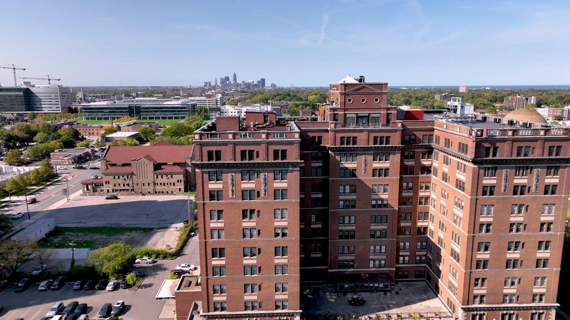 An aerial reveal of Judson Manor, the historic landmark residence in University Circle with the Cleveland skyline beyond.